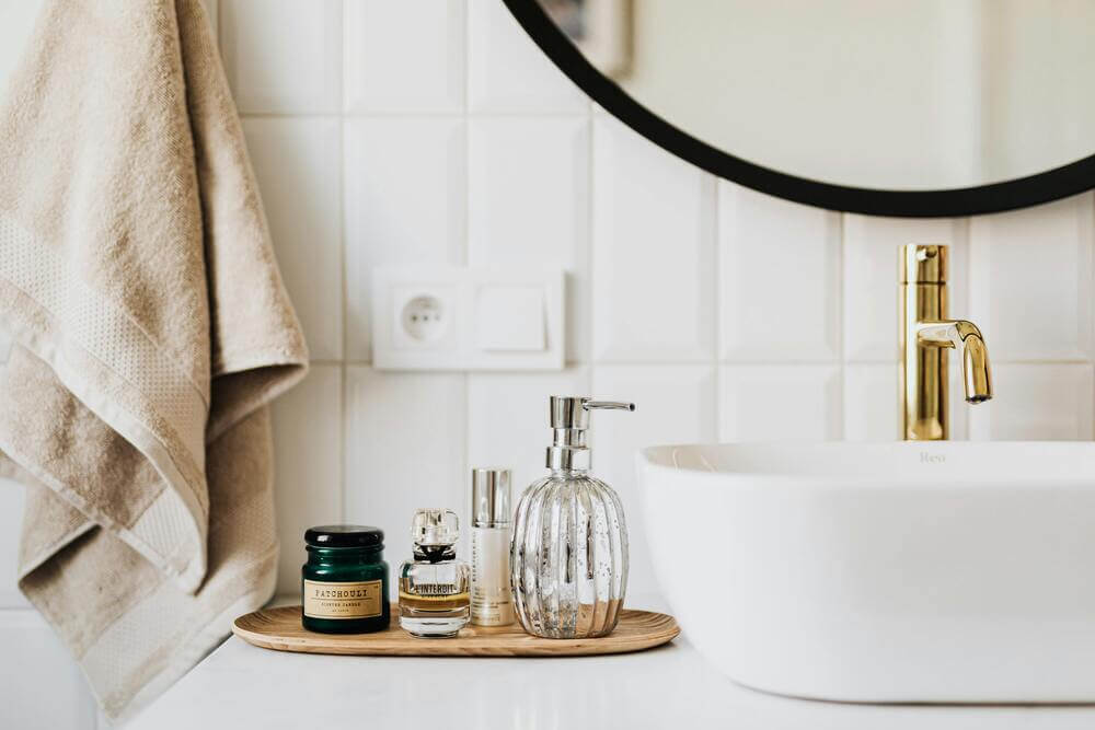 A bathroom sink with a gold basin tap. How to replace bathroom basin taps in 5 easy steps