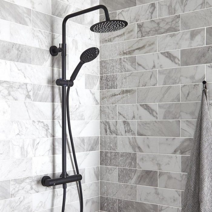 Exposed bar shower with fixed head and handheld shower hose.