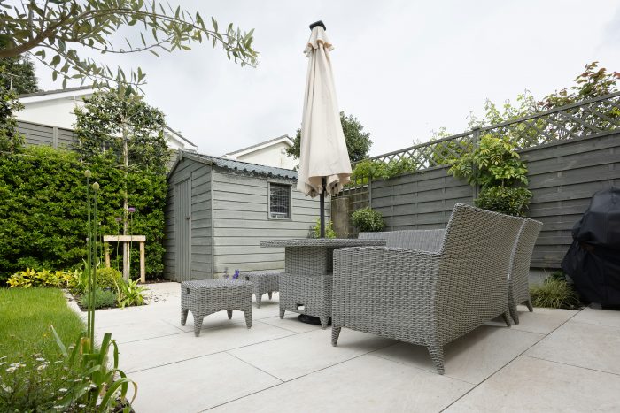 A paved patio with furniture